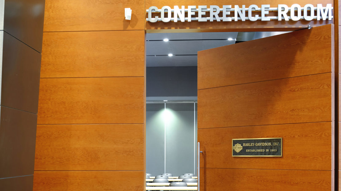 event venue and meeting space doorway showing modern wooden door and "Conference Room" lettering above
