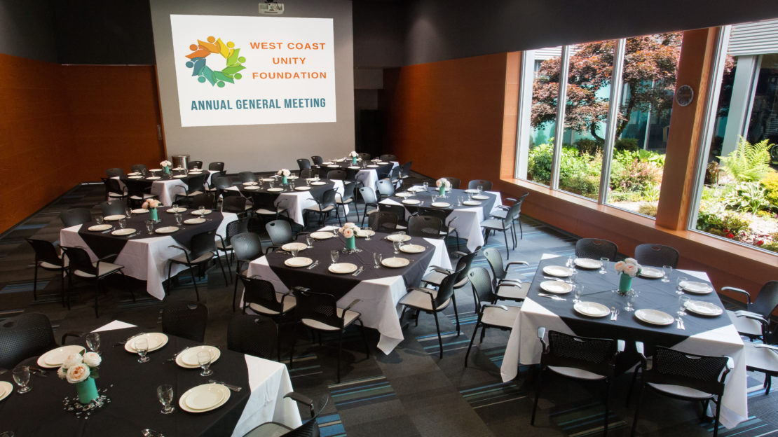event venue and meeting space showing square tables and chairs set for non-profit annual general meeting