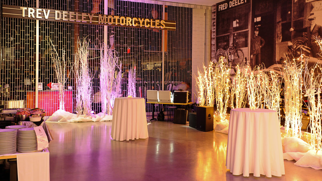 event venue and meeting space showing round high top tables and buffet for mingling.