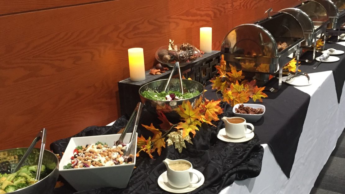 event venue and meeting space showing buffet table with food and decorations.