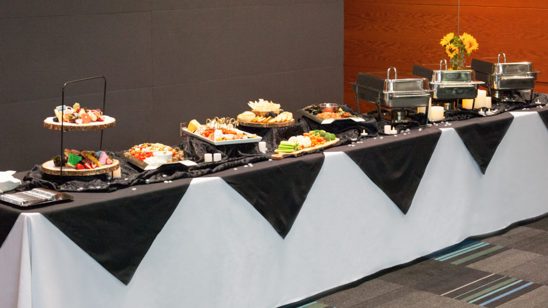 event venue and meeting space showing buffet table with food and decorations.