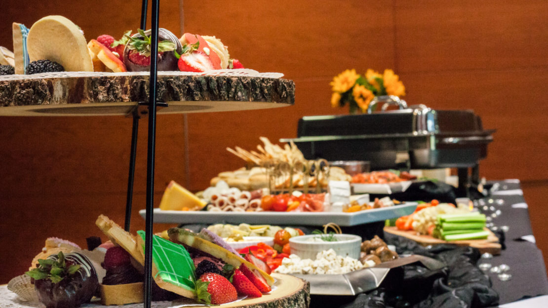 event venue and meeting space showing buffet table with food and decorations.
