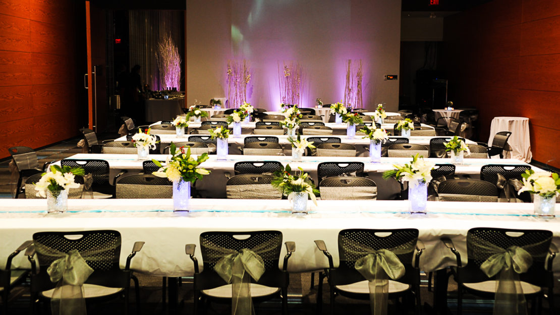 event venue and meeting space showing banquet tables and chairs set for dining.